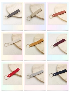 Detail showing a colorful collection of premium leather keychains with golden rivets