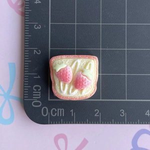 Detail shot of a 1.8cm resin strawberry toast charm for DIY accessories and crafts