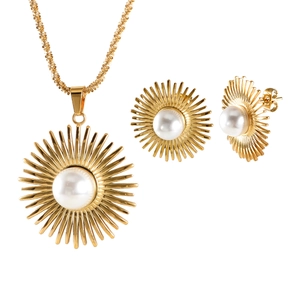 Golden sunburst jewelry set featuring pearl necklace and stud earrings on white background
