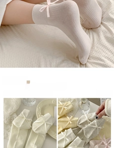 Detailed macro view of ribbed cotton socks featuring elegant silk bow decorations