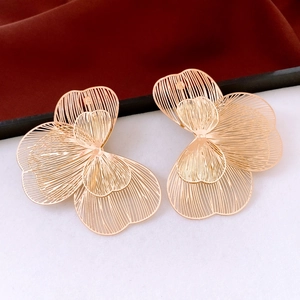 Detail view of gold floral earrings featuring multi-layered hollow wire petal design