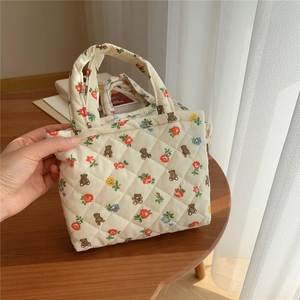 Close-up of quilted floral fabric with cute bear print on a lightweight pouch bag