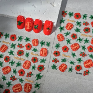 Macro shot of 3D embossed tomato nail stickers with realistic fruit slice patterns