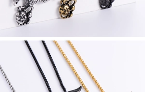Detail view of eagle skull pendants in silver, gold, and black with matching chains