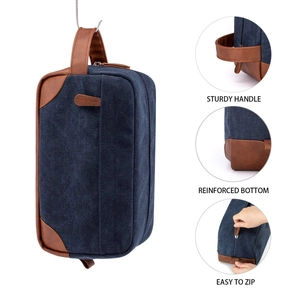 Detail view showing the sturdy handle and reinforced bottom of this canvas toiletry bag
