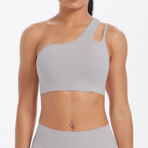 Detail of light grey asymmetric single shoulder sports bra with cutout design