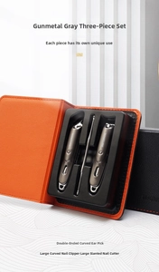 Three-piece gun grey stainless steel manicure set in black leather case with orange lining