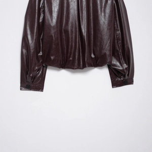 Deep burgundy faux leather bomber jacket with buttoned cuffs and elastic hem detail