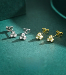 Macro shot of S925 sterling silver three-petal flower stud earrings with zircon stones