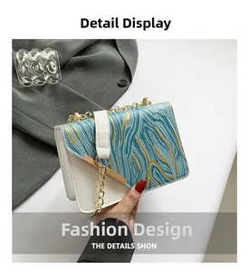 Detail of color-block flap bag featuring blue artistic ripples and gold chain strap