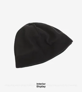 Detailed macro view of the thick black fleece lining on a winter tactical beanie hat