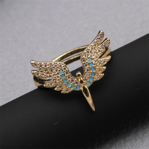 Adjustable golden angel wing ring with blue gems and clear cubic zirconia stones