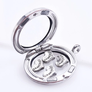 Detailed view of an open silver floating locket with four grandkids heart charms inside