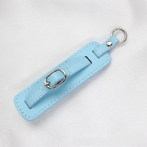 Detail of light blue PU leather strap with silver metal buckle on white silk fabric