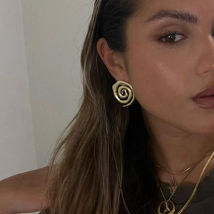 Classic 18k gold plated stainless steel spiral hoop earrings worn by a model