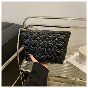 Chic black quilted clutch bag with heart pattern and gold zipper for autumn fashion