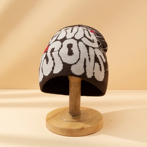 Fashionable jacquard knit beanie in dark coffee with artistic lettering and red detail