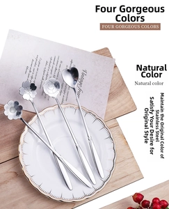 Macro view of 4-piece stainless steel spoon set with cherry and rose floral head designs
