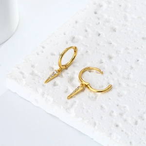 Macro detail of gold S925 sterling silver hoop earrings with sparkling zircon cone charms