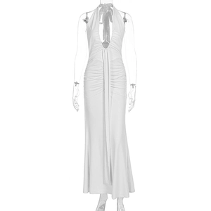 Detail of elegant white halter neck maxi dress with deep V-neck and ruched texture fabric