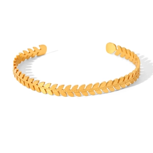 Close-up of golden wheat ear textured bangle with polished 18k gold plated finish