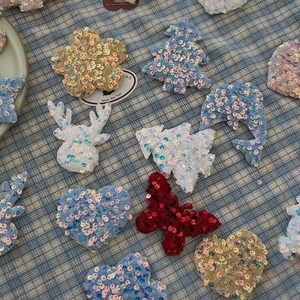 Sparkling sequin Christmas tree ornaments and festive fabric appliques in various shapes