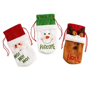 Three Christmas drawstring wine gift bags featuring Santa, snowman, and reindeer designs