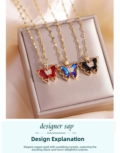 Detailed close-up of double-layer crystal butterfly pendants in red blue and black