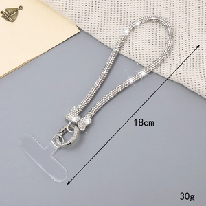 Macro shot of 18cm sparkling rhinestone bow phone strap with silver lobster clasp and TPU pad
