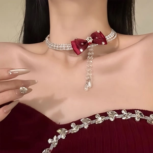 Detail of velvet bow necklace with rhinestone fringe and water drop pearl pendant