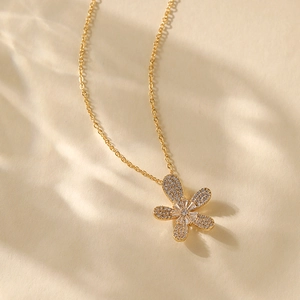 Macro shot of 18K gold plated fan-shaped pendant necklace with cubic zirconia
