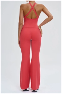 Detail of cross-back yoga vest and high-waist flared pants in coral red sport fabric