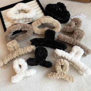 Chic plush faux fur hair claw clips in various neutral colors for women's winter styling