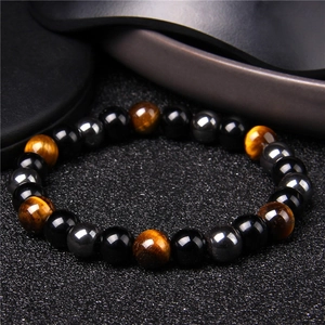 Macro shot of 8mm hematite obsidian and tiger eye beaded energy bracelet for men