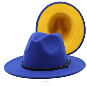 Detail view of navy blue fedora hat with contrast yellow brim and black leather band