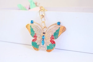 Macro detail of golden butterfly keychain featuring vibrant colorful rhinestones and crystals