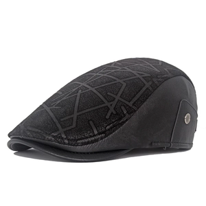 Detail of black patchwork ivy cap showing geometric fabric texture and leather side panels