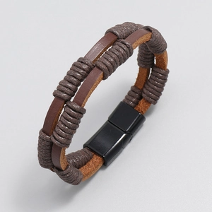 Macro view of multi-layer brown braided leather bracelet with black magnetic clasp