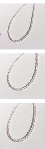 Detailed close-up showing texture and luster of round white pearl strand necklace