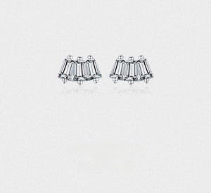 Macro detail of s925 silver fan-shaped earrings with baguette-cut zircon stones