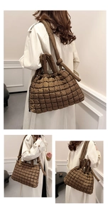 Brown quilted puffer tote bag with knotted shoulder strap shown from a back side view