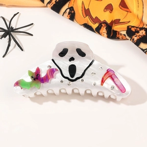 Macro detail of Halloween hair claw clip with scream mask motif and rhinestone accents