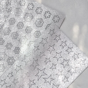Shiny silver glitter nail art stickers with snowflake and star patterns for DIY manicures