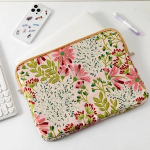 Floral embroidered laptop sleeve detail showing high-quality fabric and golden zipper