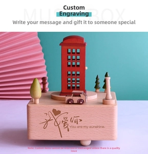 Detailed macro view of a wooden music box with a red phone booth and engraved base