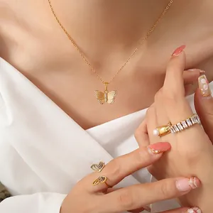 Elegant gold butterfly necklace with zircon stones and matching pearl rings on model