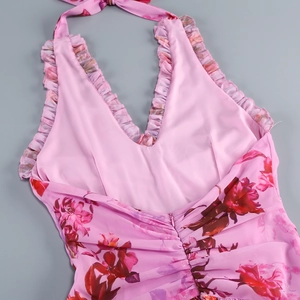 Detail of pink floral halter dress showing ruffled neckline and back invisible zipper