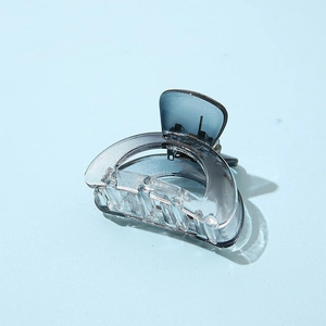 Detailed view of a semi-circular gradient grey-blue acetate hair claw with metal spring