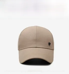 Detailed macro view of khaki baseball cap featuring ripstop texture and metal shield emblem