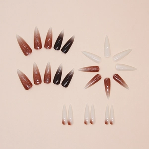 Long stiletto press-on nails featuring various brown and white gradient shades set